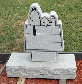 This is a gray, single monument, in a sleeping snoopy style.