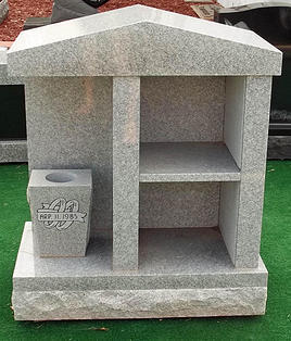This is the front of a gray, double, cremation monument that comes with black doors, a great choice for a family memorial.