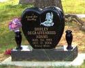 This is a black, single upright monument in a heart style, with a beautiful angel and two vases.