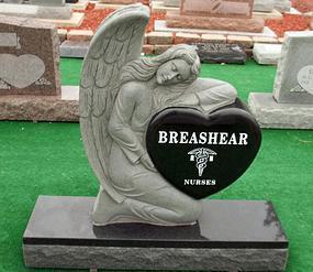 This is a gray and black, single, upright monument with a detailed angel laying over a black heart.