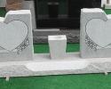 This is a gray, double monument, with two hearts to encase your loved ones memories.