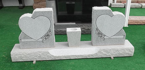 This is a gray, double monument, with two hearts to encase your loved ones memories.